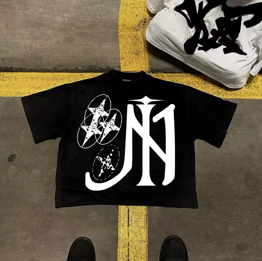 Close editorial view of the INNERSIDE 001 T-shirt on concrete, showing the star graphic and the yellow rectangle detail.